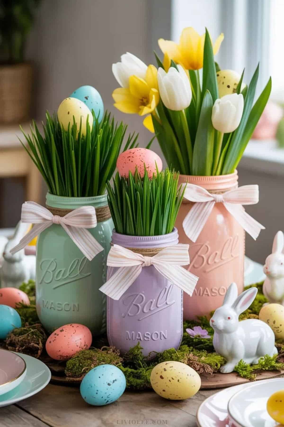 Easter table centerpiece using decorated mason jars with eggs and flowers