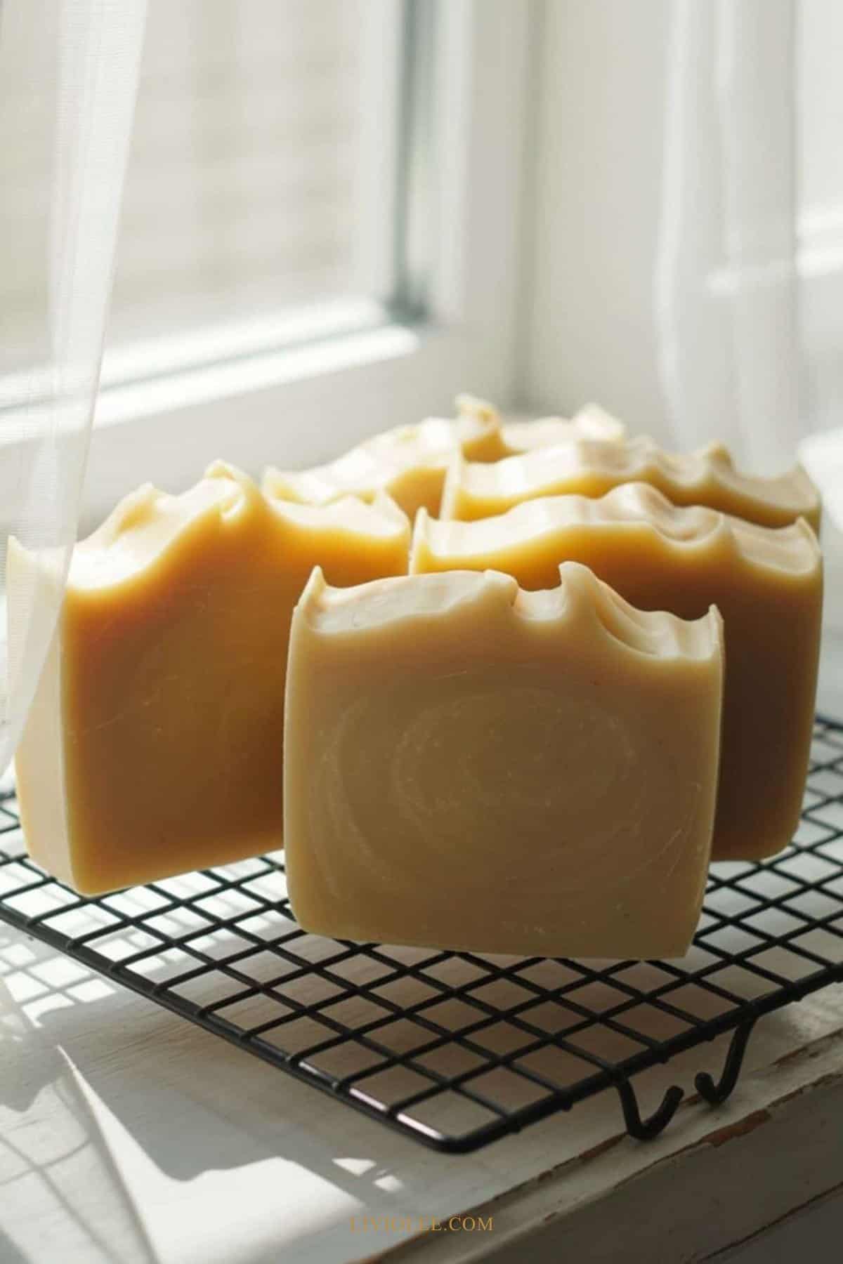 goat’s milk soap bars cooling on a rack