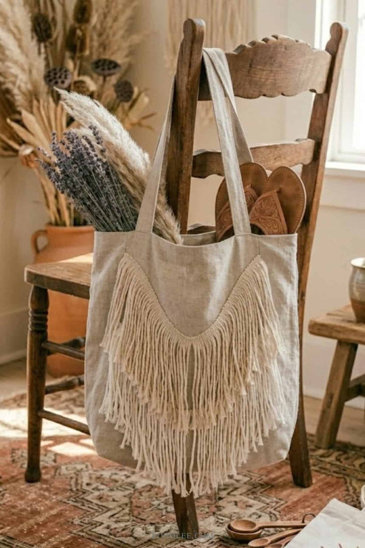 boho tote bag with fringe detail in neutral fabric hanging