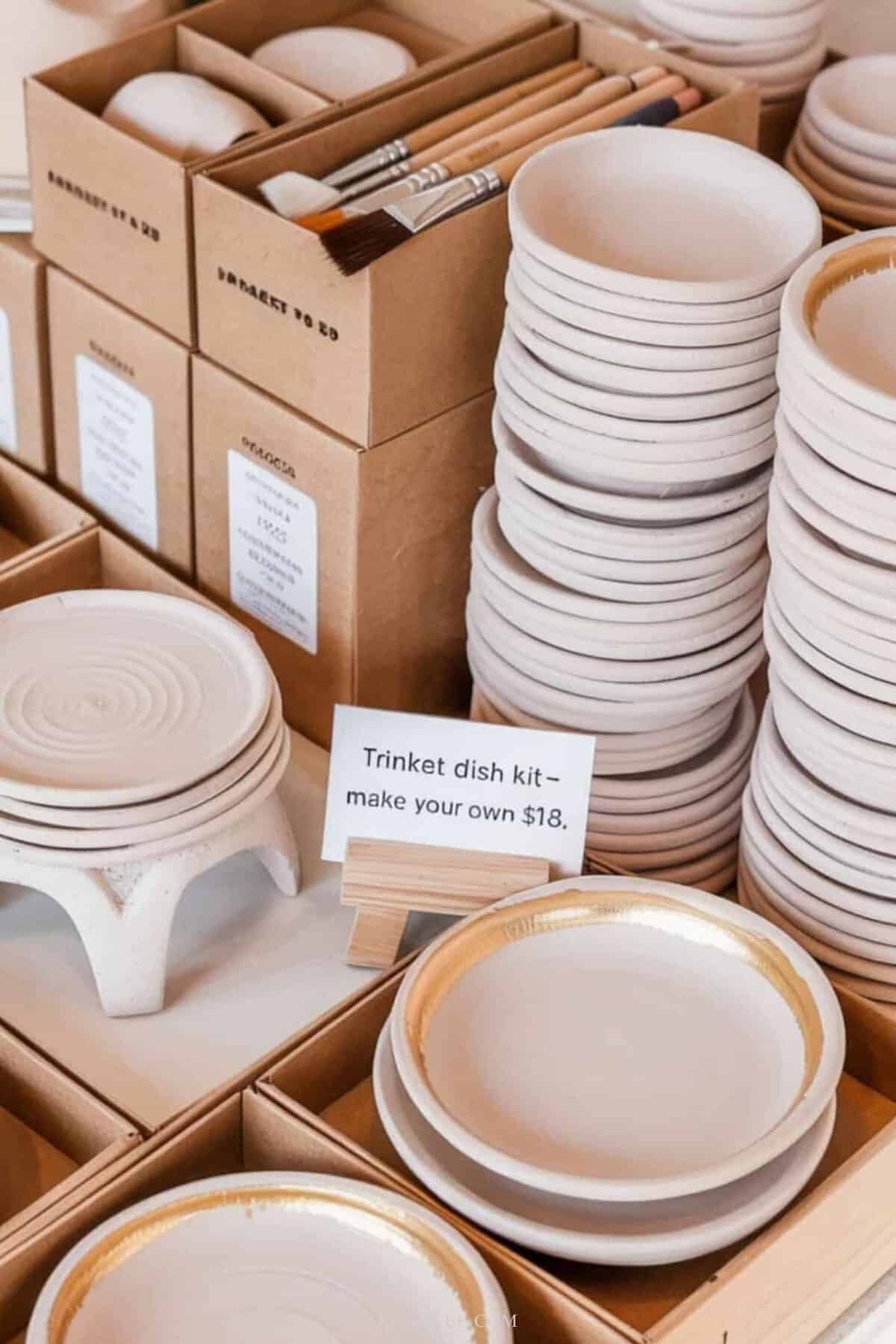 	
clay trinket dish kits arranged on a craft market shelf