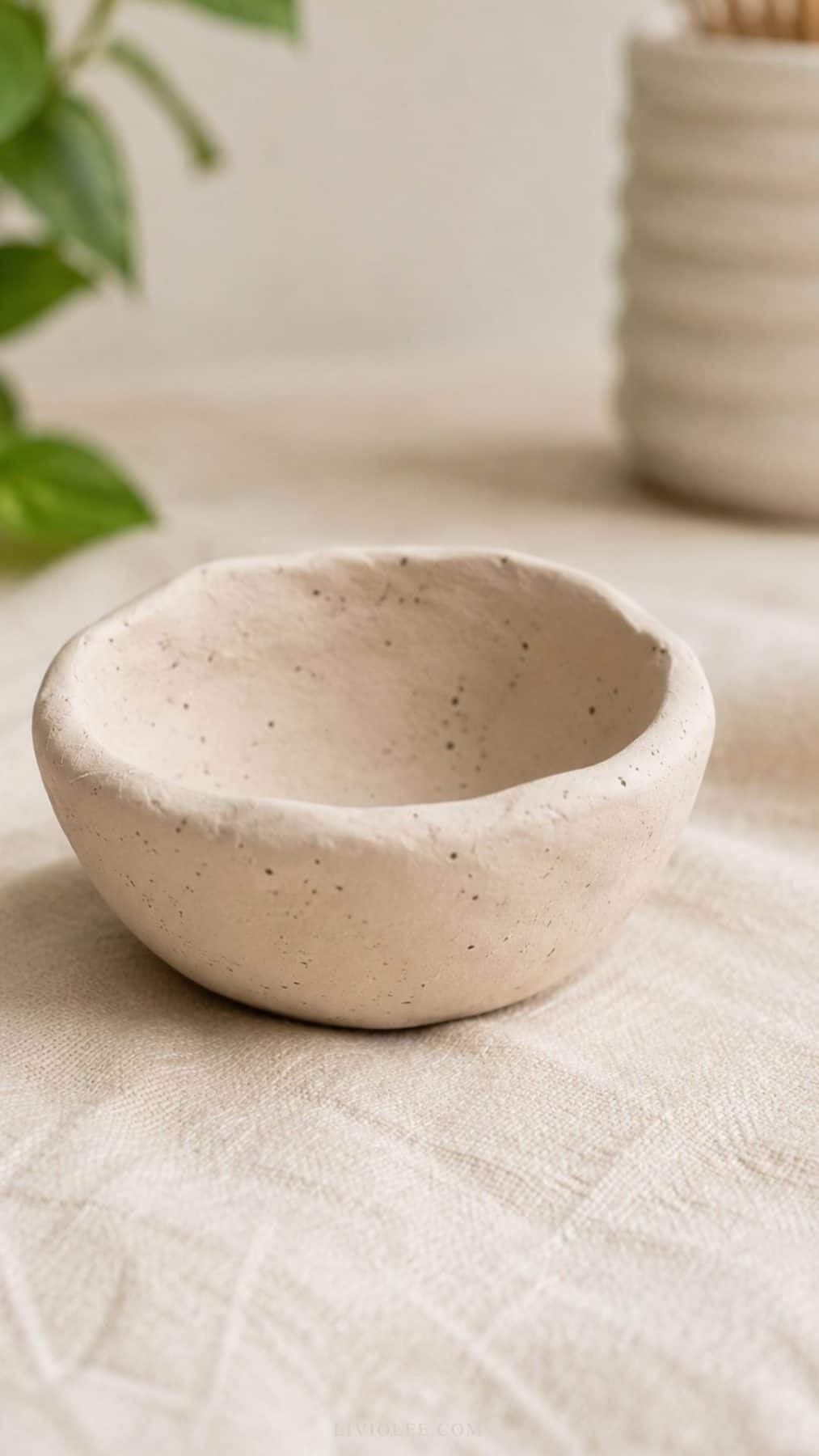 Minimalist handmade air dry clay pinch pot bowl with an organic uneven rim